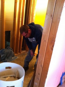 Nate working on subfloor patching in master bath