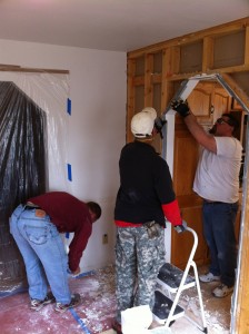 Bobby, Dre', and Norm demo'ing the kitchen wall