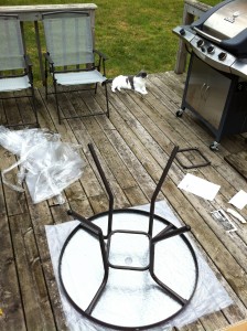 Assembling new patio set with Kitty supervising